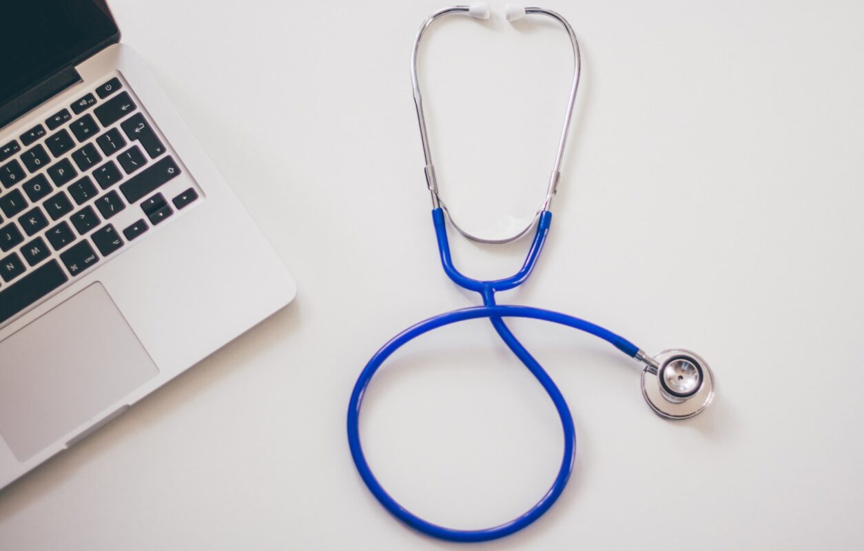 doctor with a serious face is holding a white notepad|||medical equipment